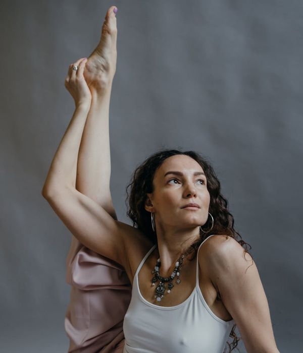 Woman in a calm, balanced yoga pose, illustrating harmony.